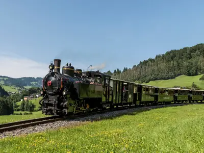 Bersbuch, Austria - July 22, 2017: Steam locomotive of the Bregenzerwaldbahn, 'Waelderbaenle', in the mountains of the Bregenzerwald, driving trough the alpine meadows, Austria.