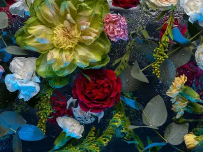 Abstract floral background with neon lights. Baroque old fashiones style. Creative layout made of flowers and leaves on black background. Flat lay. Floral greeting card