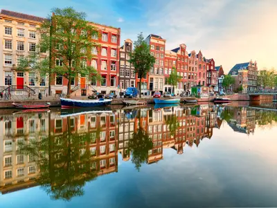 Beautiful Amsterdam sunset. Typical old dutch houses on the bridge and canals in spring, Netherlands