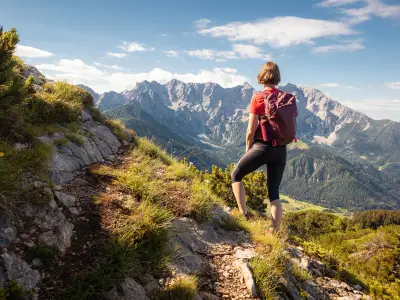 Woman backpacker enjoy the view at mountain hike in nature.