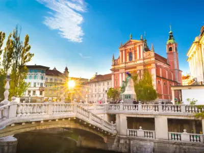 Romantic Ljubljana's city center:  river Ljubljanica, Triple Bridge (Tromostovje), Preseren square and Franciscan Church of the Annunciation; Ljubljana, Slovenia, Europe.